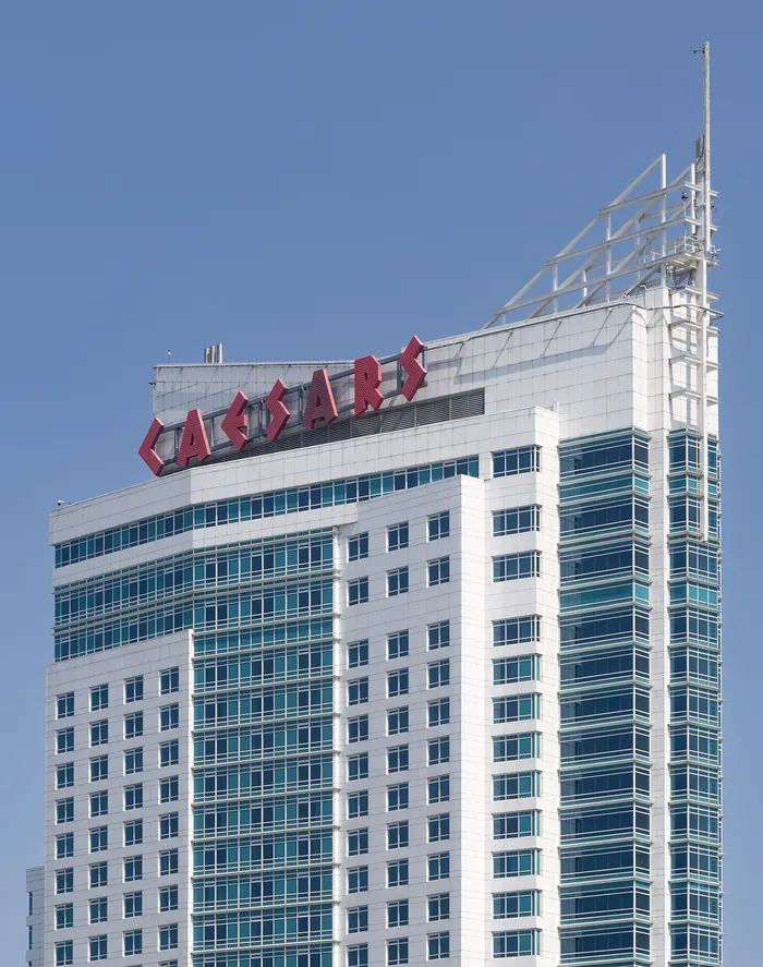 Photograph: the top of the Forum Tower hotel at Caesars Windsor with red lettering against a blue sky.